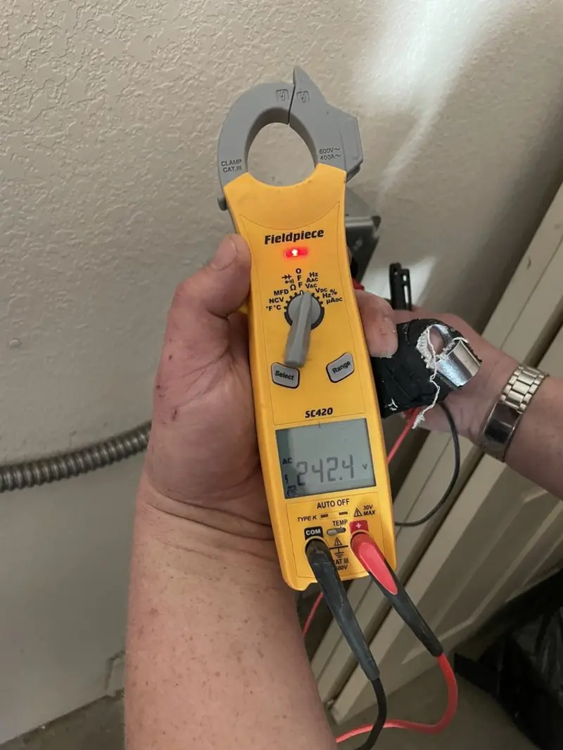 Voltage testing with clamp meter during Outlet Installation in Beecher